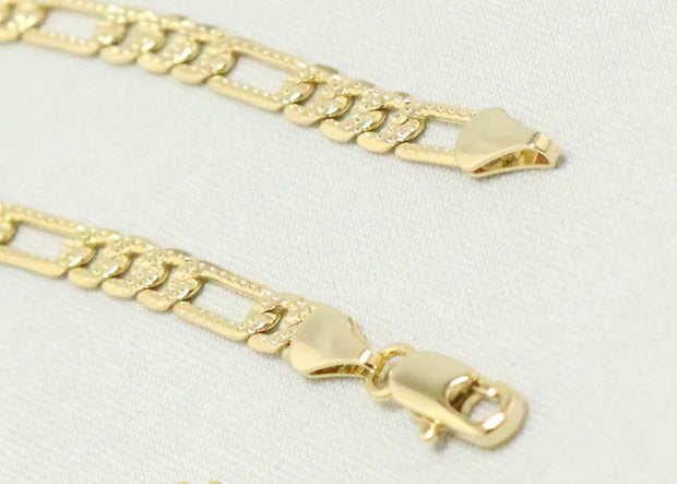 Figaro chain with gold indented cross charm
