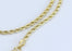 Rope chain with small diamond tied cross charm